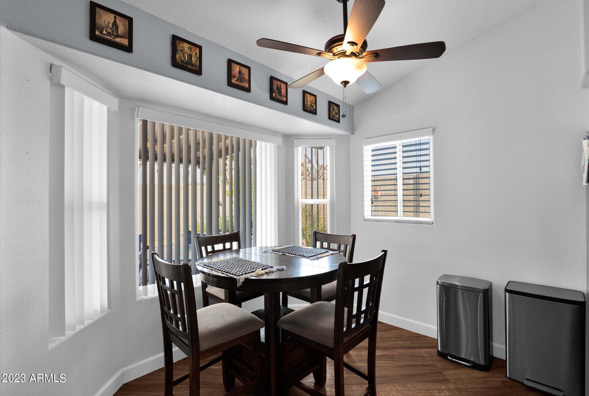 4338 East Douglas Avenue Gilbert, AZ 85234 - Photo 15 of 48 a view of a dining room with furniture window and wooden floor