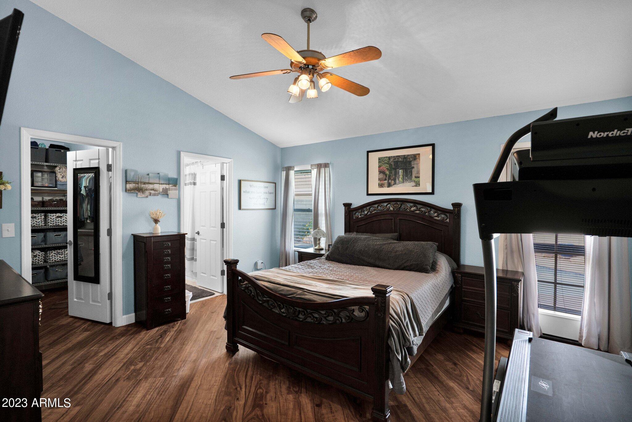 4338 East Douglas Avenue Gilbert, AZ 85234 - Photo 16 of 48 a bedroom with a bed and wooden floor