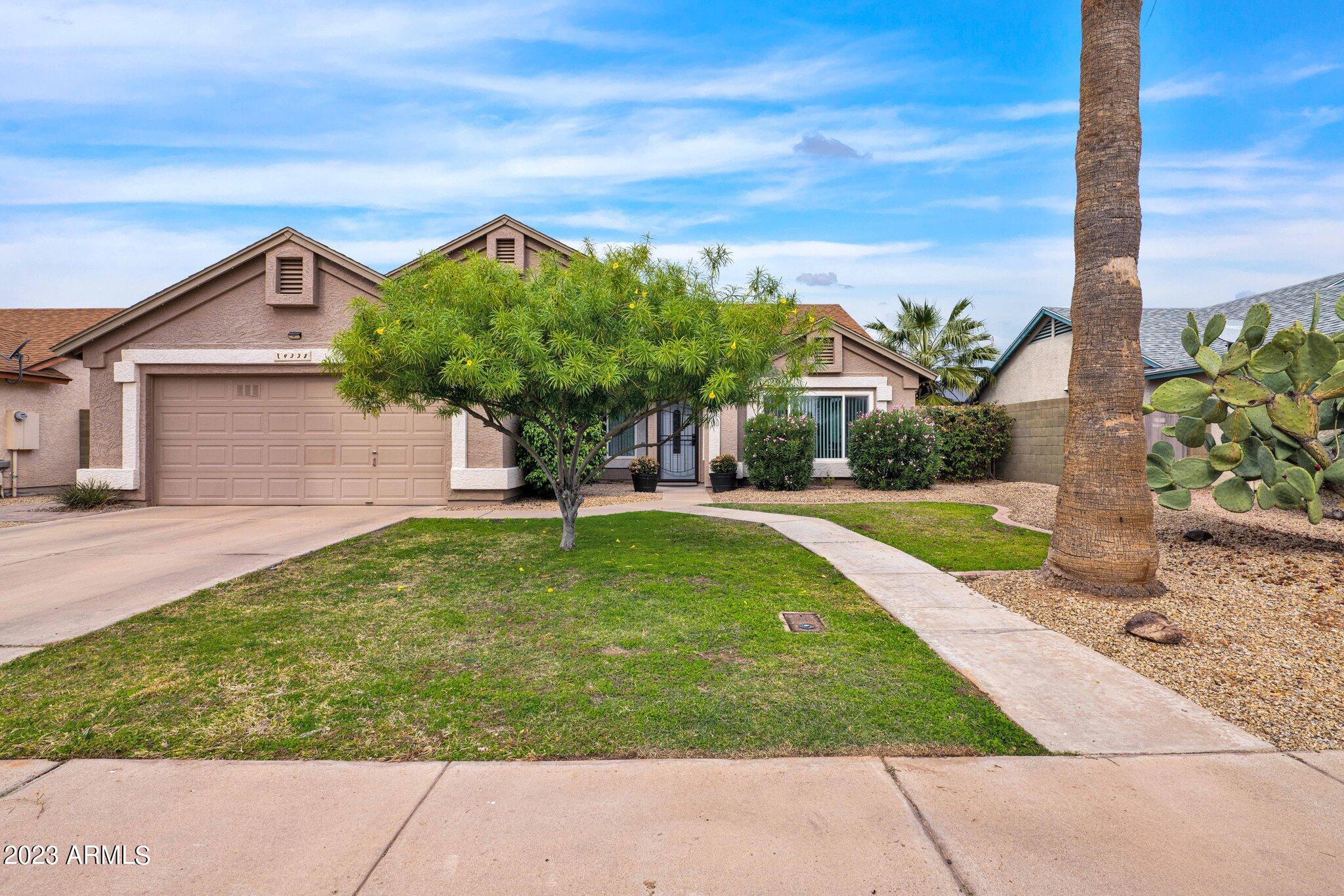 4338 East Douglas Avenue Gilbert, AZ 85234 - Photo 2 of 48 a view of a house with a yard