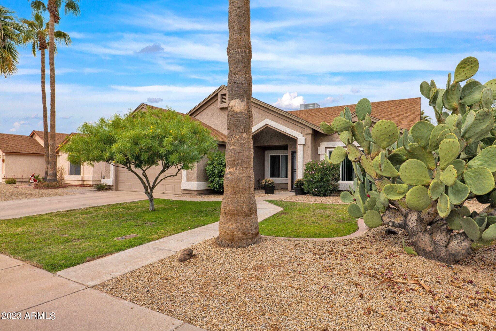 4338 East Douglas Avenue Gilbert, AZ 85234 - Photo 3 of 48 a front view of a house with garden