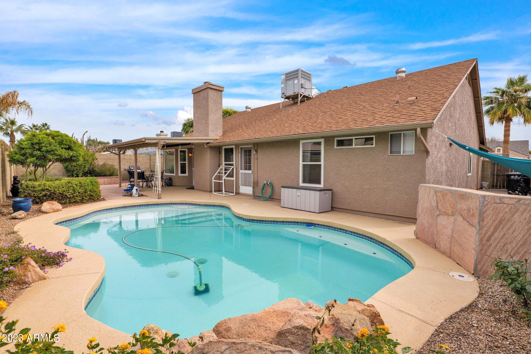 4338 East Douglas Avenue Gilbert, AZ 85234 - Photo 33 of 48 a view of a house with swimming pool and sitting area