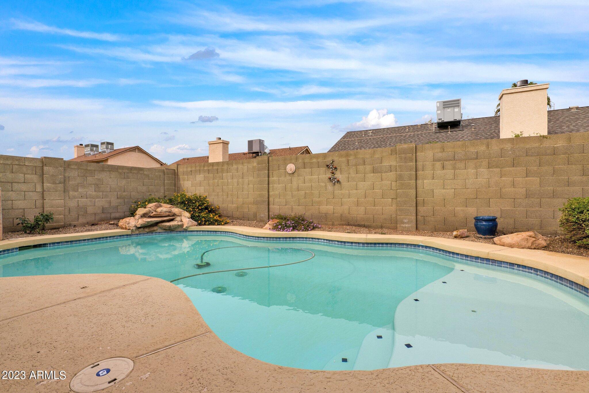 4338 East Douglas Avenue Gilbert, AZ 85234 - Photo 34 of 48 a view of a swimming pool with a yard