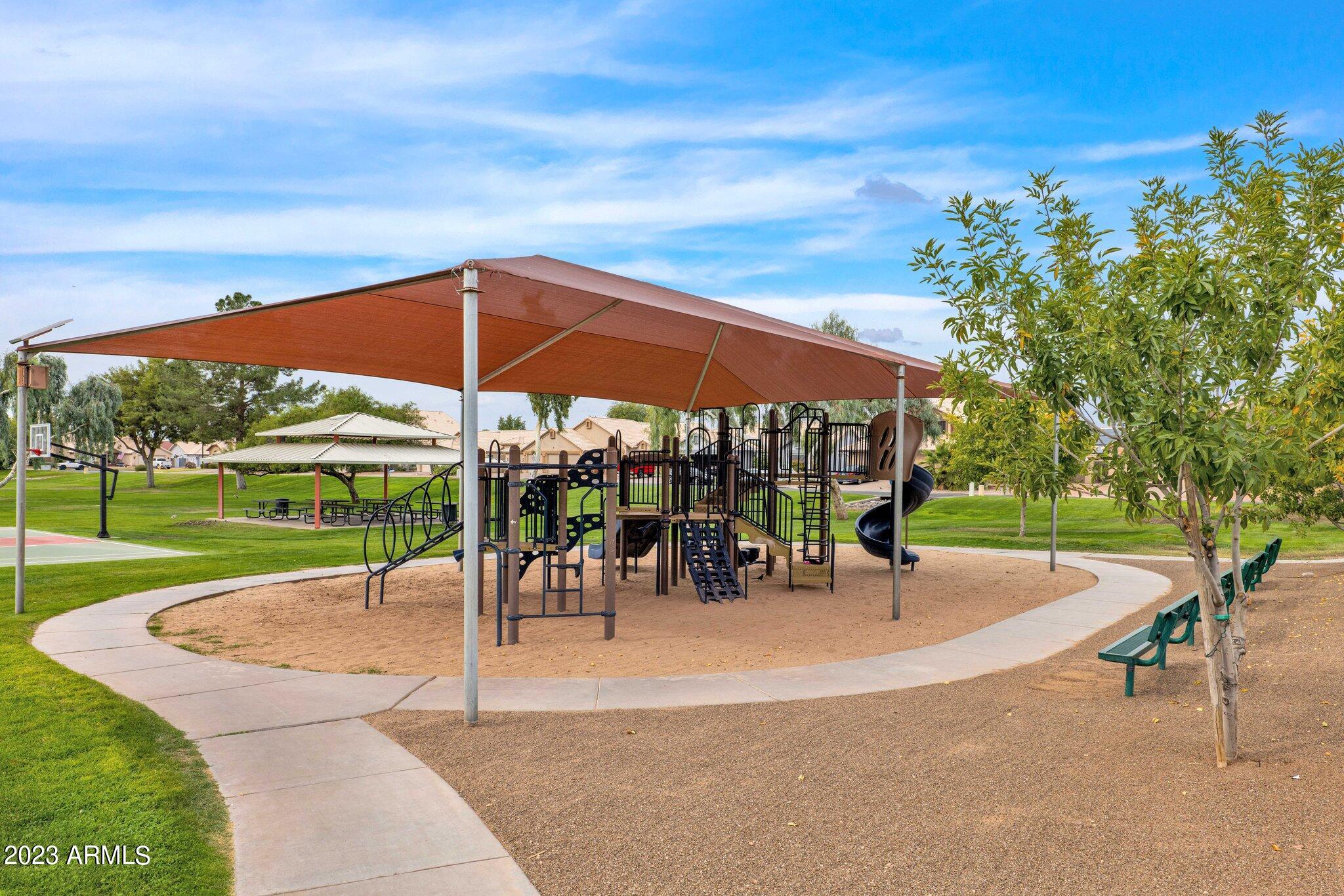 4338 East Douglas Avenue Gilbert, AZ 85234 - Photo 39 of 48 a view of a patio with a table and chairs under an umbrella