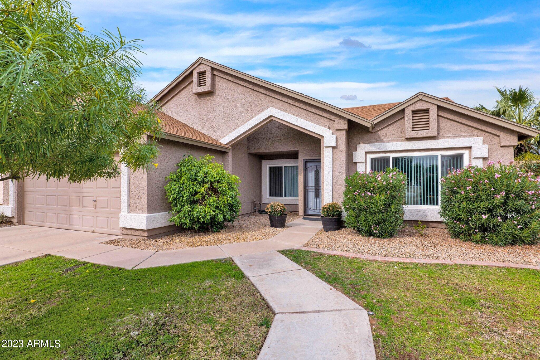4338 East Douglas Avenue Gilbert, AZ 85234 - Photo 4 of 48 a front view of a house with a yard