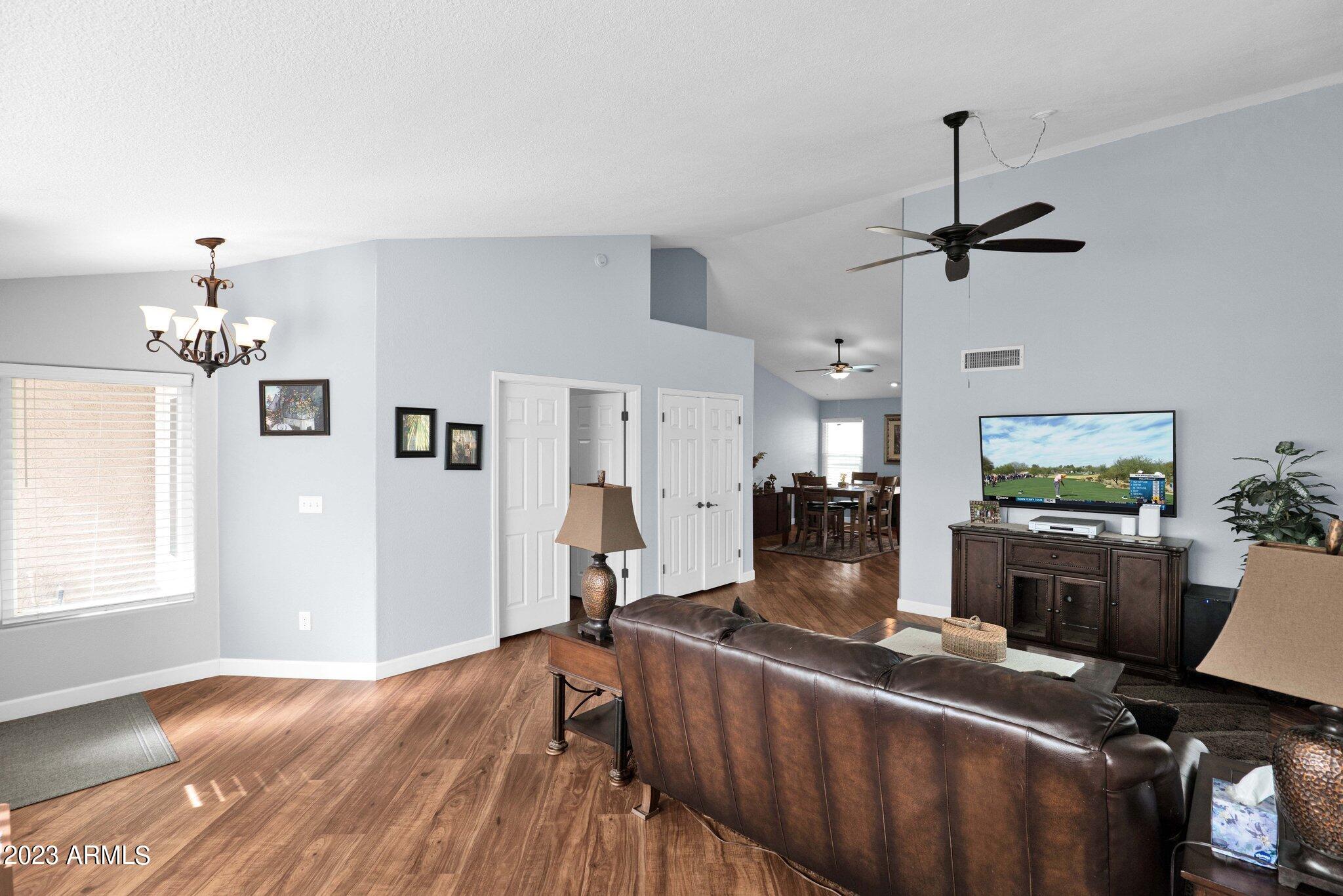 4338 East Douglas Avenue Gilbert, AZ 85234 - Photo 7 of 48 a living room with furniture a flat screen tv and a window