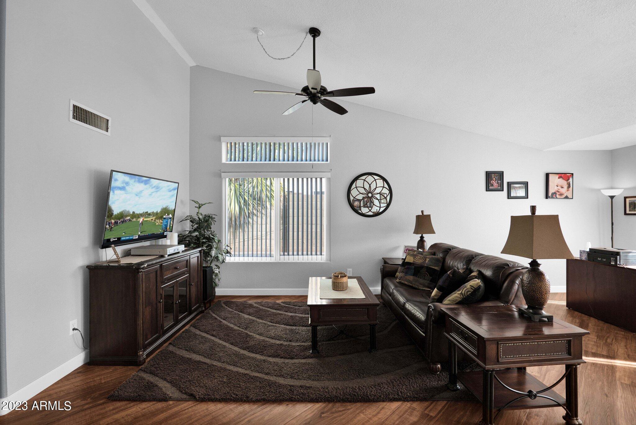 4338 East Douglas Avenue Gilbert, AZ 85234 - Photo 10 of 48 a living room with furniture a window and a clock