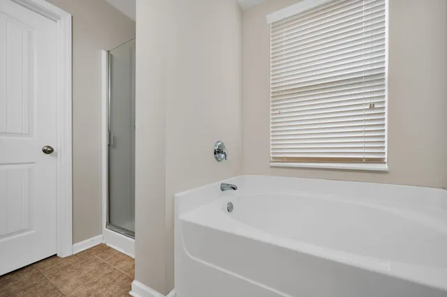 a white bath tub sitting next to a window