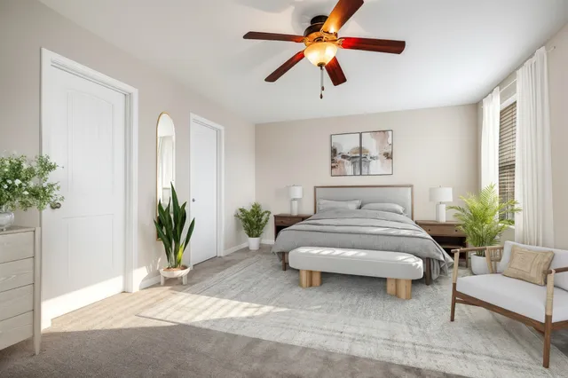 a spacious bedroom with a large bed and a couch