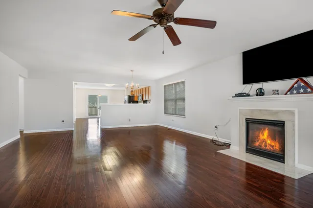 a living room with a fireplace a flat screen tv and a fireplace
