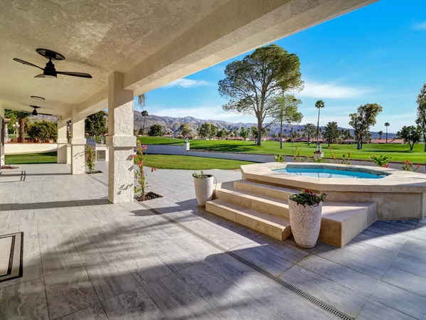 a view of swimming pool with outdoor seating and yard in back