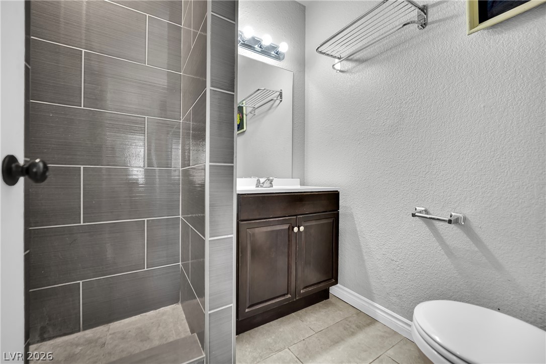 420 North Racetrack Road Henderson, NV 89015 - Photo 24 of 52 A well-appointed bath features a tiled shower and vanity with ample storage.