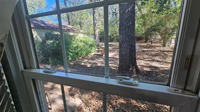 a view of a room with wooden floor and outdoor space