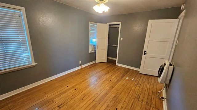 a view of a room with wooden floor and staircase