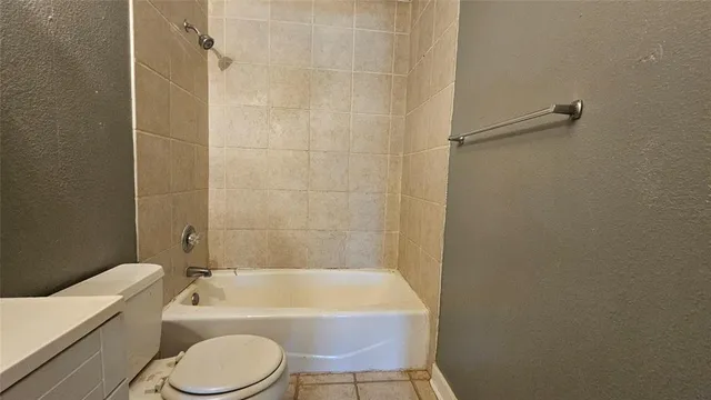 a bathroom with a toilet bathtub sink vanity and shower