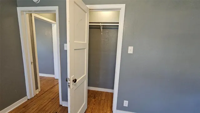 a view of walk in closet with wooden floor