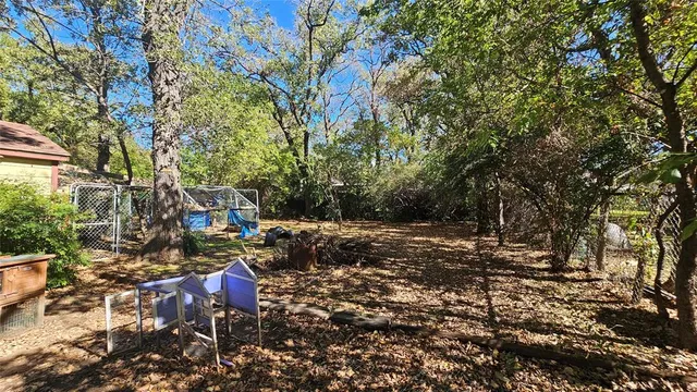 a backyard of a house with table and chairs