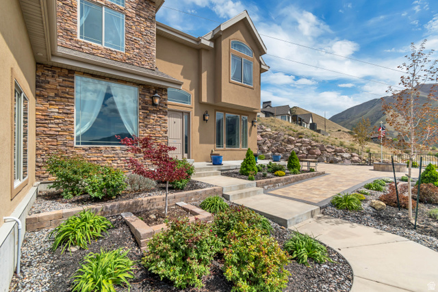 2543 East 700 South Springville, UT 84663 - Photo 5 of 73 View of exterior entry featuring stone siding, stucco siding, and a mountain view