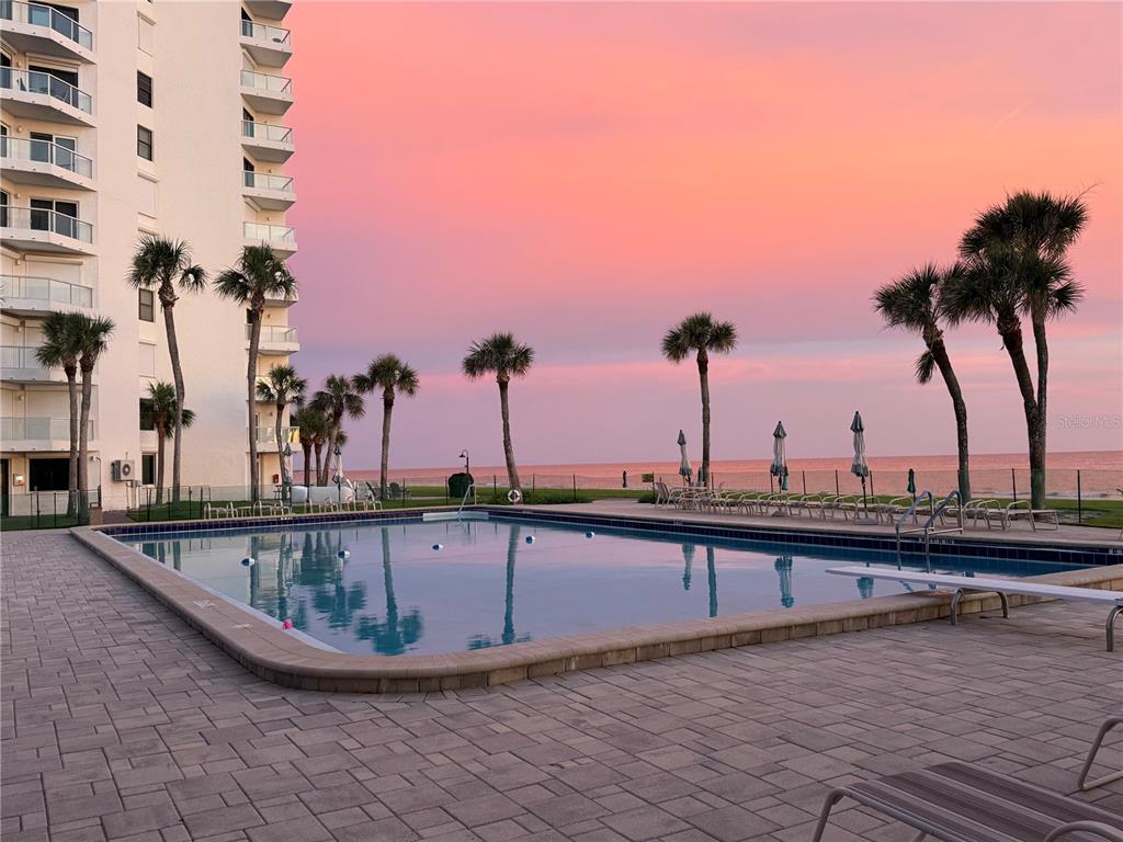 1050 Longboat Club Road, Unit 901 Longboat Key, FL 34228 - Photo 28 of 37 a view of a swimming pool with a table and chairs