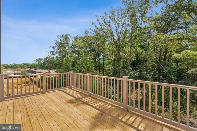 a balcony with wooden floor and fence
