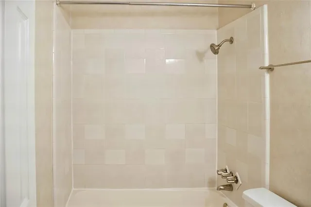 a bathroom with a shower and a toilet
