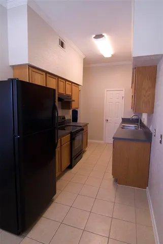 a kitchen with stainless steel appliances a refrigerator and a stove