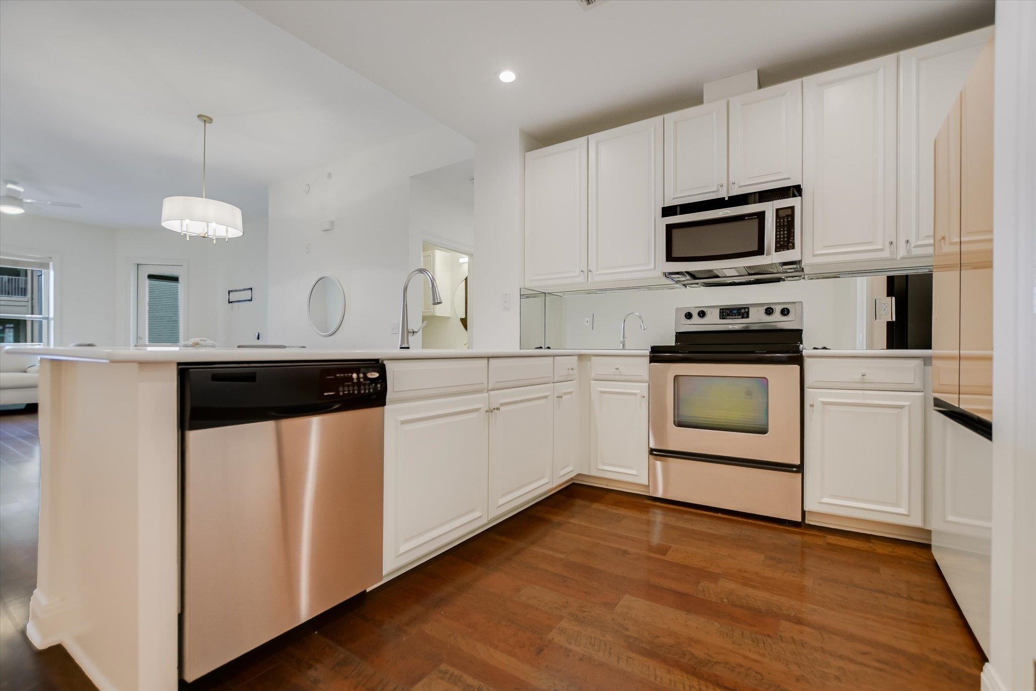 101 West Bank, Unit 52 Horseshoe Bay, TX 78657 - Photo 2 of 30 a kitchen with white cabinets stainless steel appliances and sink