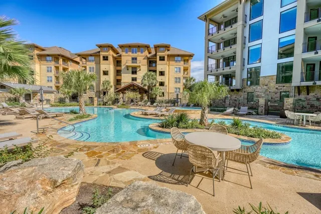 a view of a swimming pool with a lounge chairs