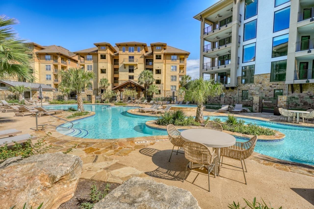 101 West Bank, Unit 52 Horseshoe Bay, TX 78657 - Photo 23 of 30 a view of a swimming pool with a lounge chairs