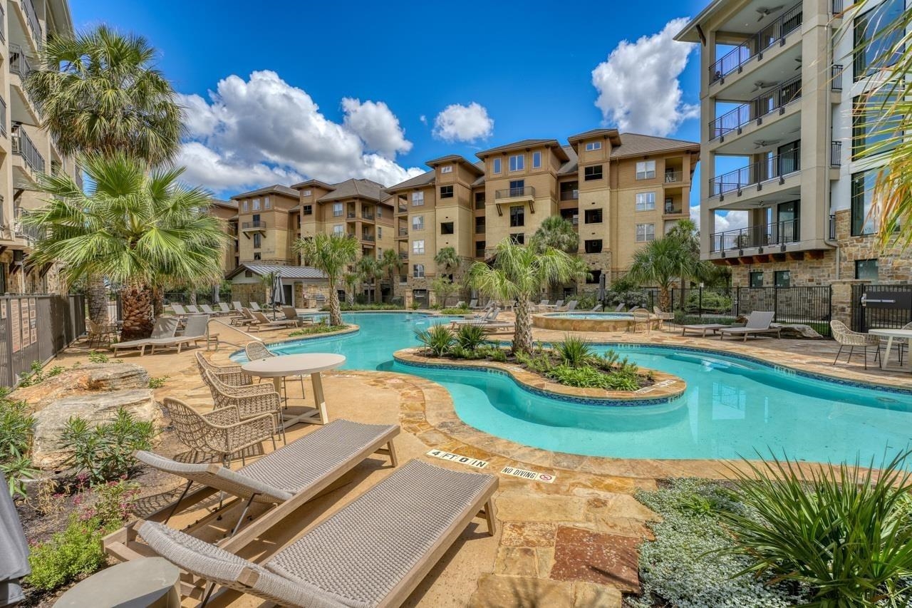 101 West Bank, Unit 52 Horseshoe Bay, TX 78657 - Photo 24 of 30 a view of a swimming pool with a lounge chairs