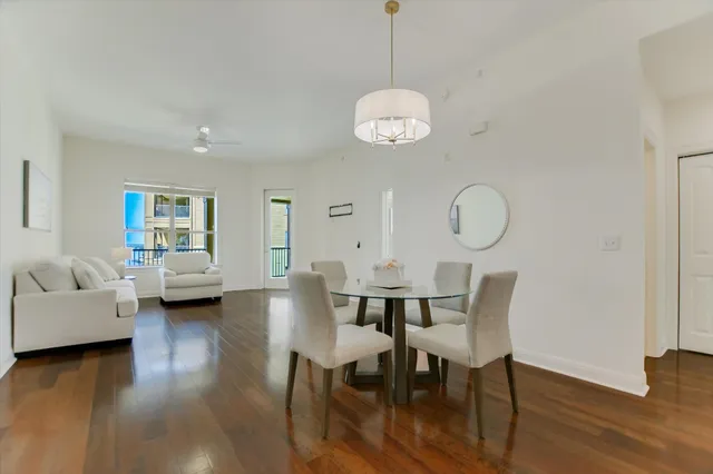 a view of a dining room with furniture wooden floor and chandelier