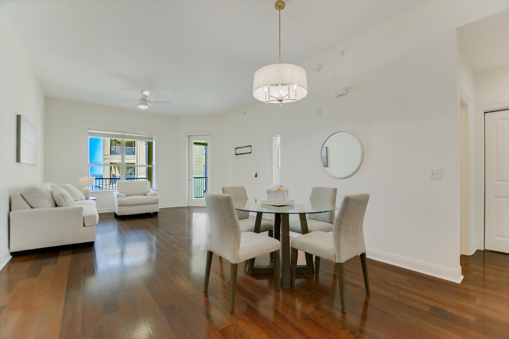 101 West Bank, Unit 52 Horseshoe Bay, TX 78657 - Photo 6 of 30 a view of a dining room with furniture wooden floor and chandelier