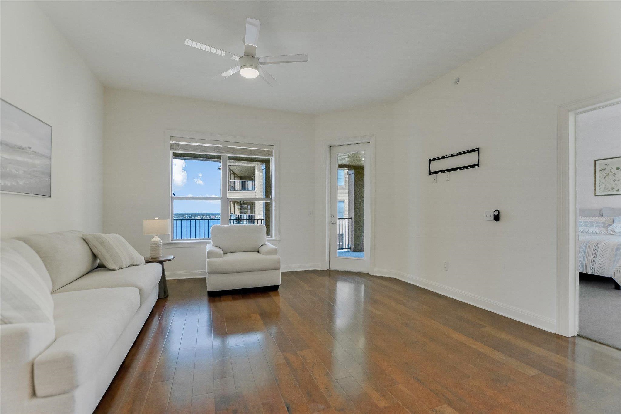 101 West Bank, Unit 52 Horseshoe Bay, TX 78657 - Photo 8 of 30 a living room with furniture and a large window