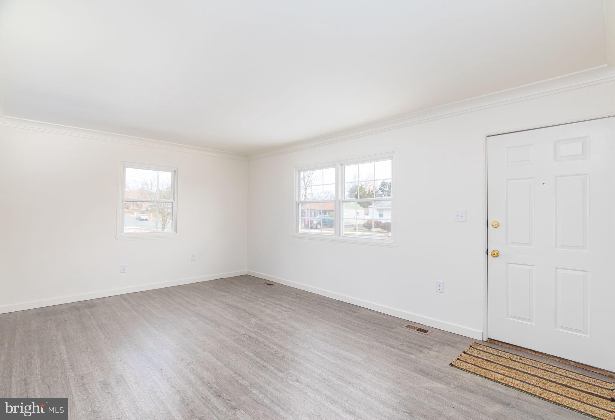 8 South Reed Street Bel Air, MD 21014 - Photo 6 of 21 an empty room with wooden floor and windows
