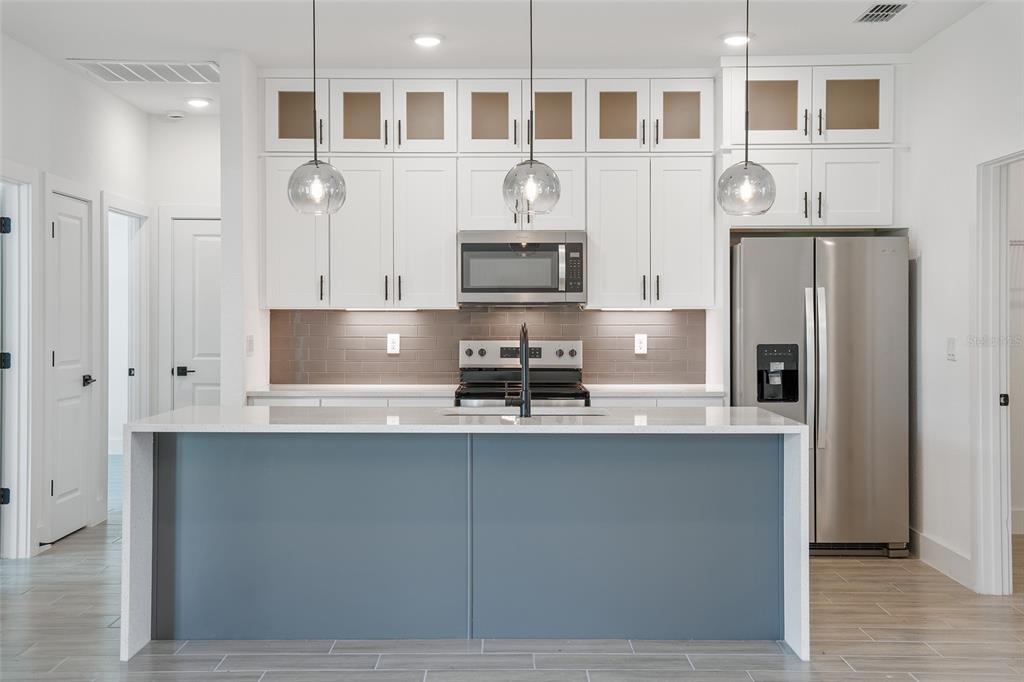 24419 Southwest Kingsway Circle Punta Gorda, FL 33983 - Photo 13 of 51 a kitchen with stainless steel appliances granite countertop a refrigerator and a stove top oven