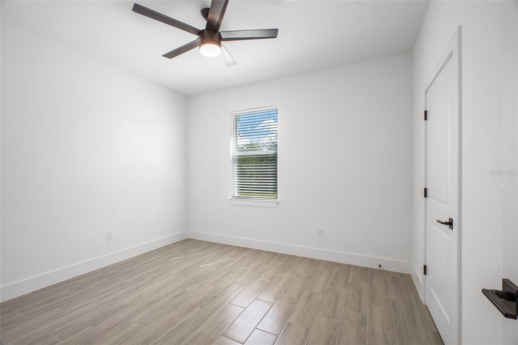 24419 Southwest Kingsway Circle Punta Gorda, FL 33983 - Photo 24 of 51 wooden floor in an empty room with a window