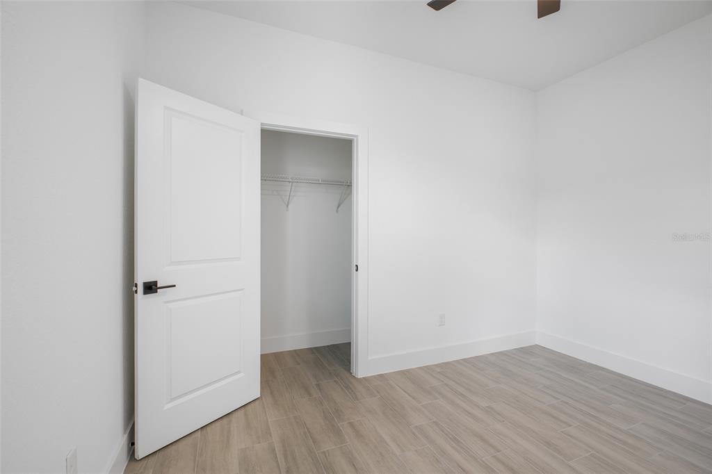 24419 Southwest Kingsway Circle Punta Gorda, FL 33983 - Photo 34 of 51 a view of an empty room with wooden floor