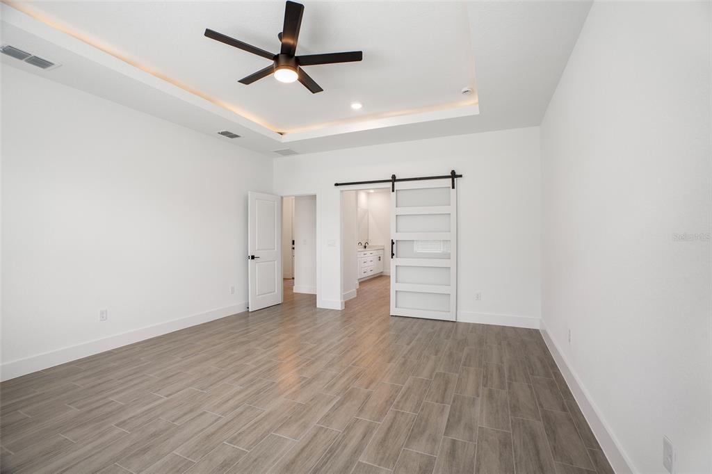 24419 Southwest Kingsway Circle Punta Gorda, FL 33983 - Photo 35 of 51 an empty room with wooden floor and windows