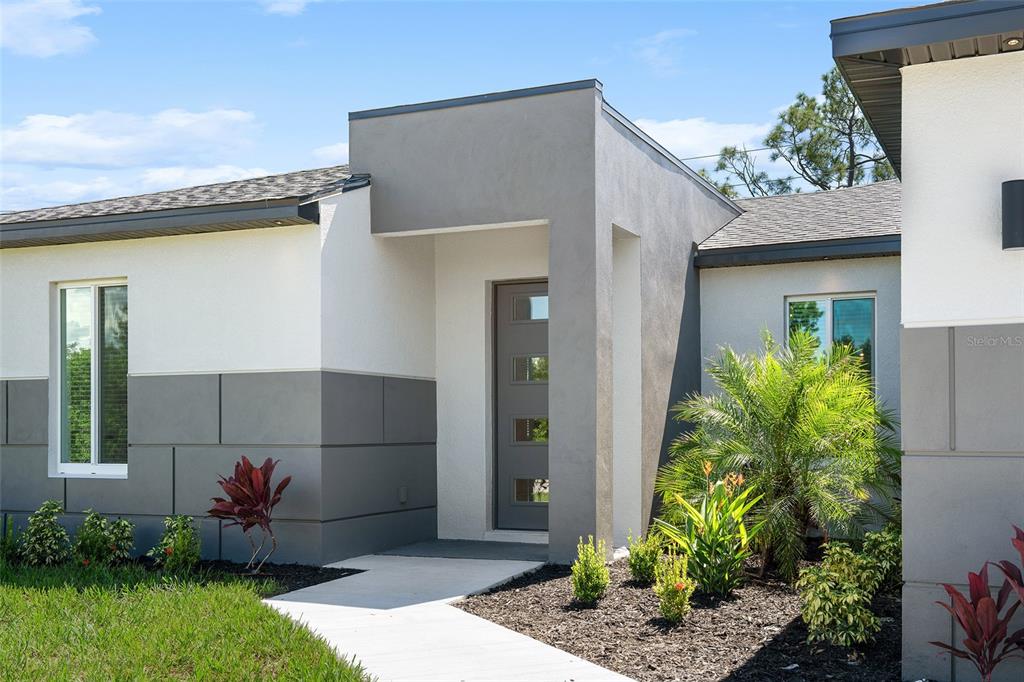 24419 Southwest Kingsway Circle Punta Gorda, FL 33983 - Photo 7 of 51 a front view of a house with a porch