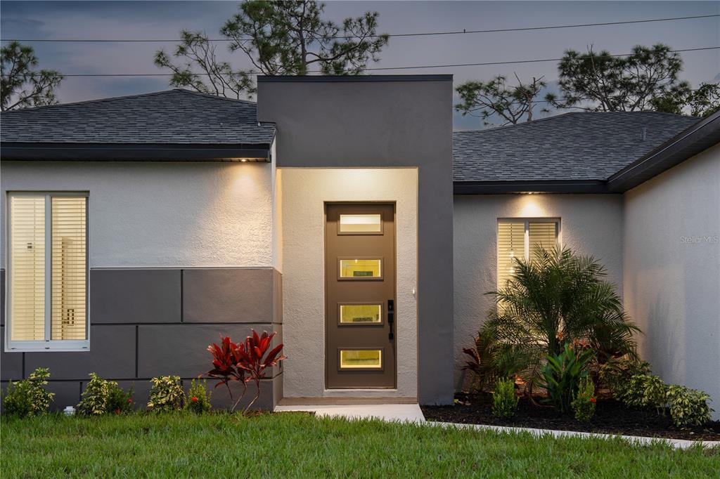 24419 Southwest Kingsway Circle Punta Gorda, FL 33983 - Photo 9 of 51 a front view of a house with garden
