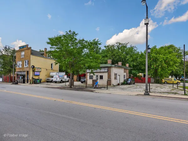 a street sign on a sidewalk next to a road