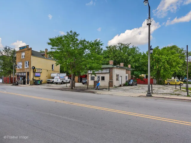 a street sign on a sidewalk next to a road