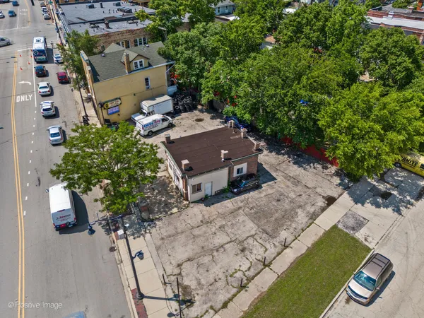 an aerial view of a house with a yard