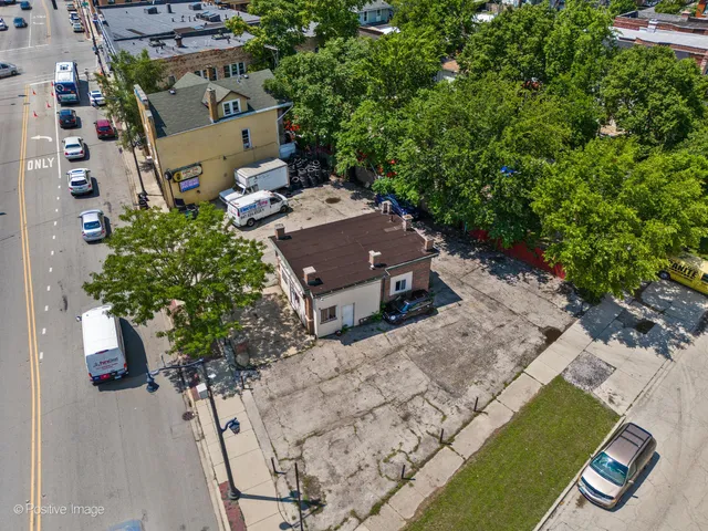 an aerial view of a house with a yard