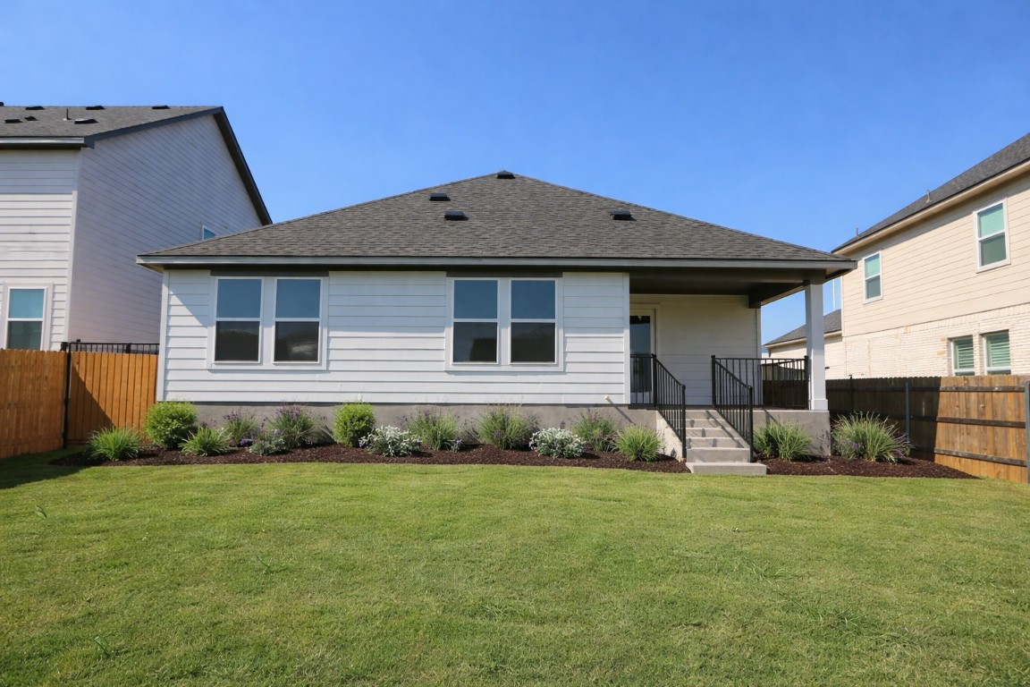 11905 Dillon Fls Drive Austin, TX 78747 - Photo 8 of 9 a front view of a house with garden