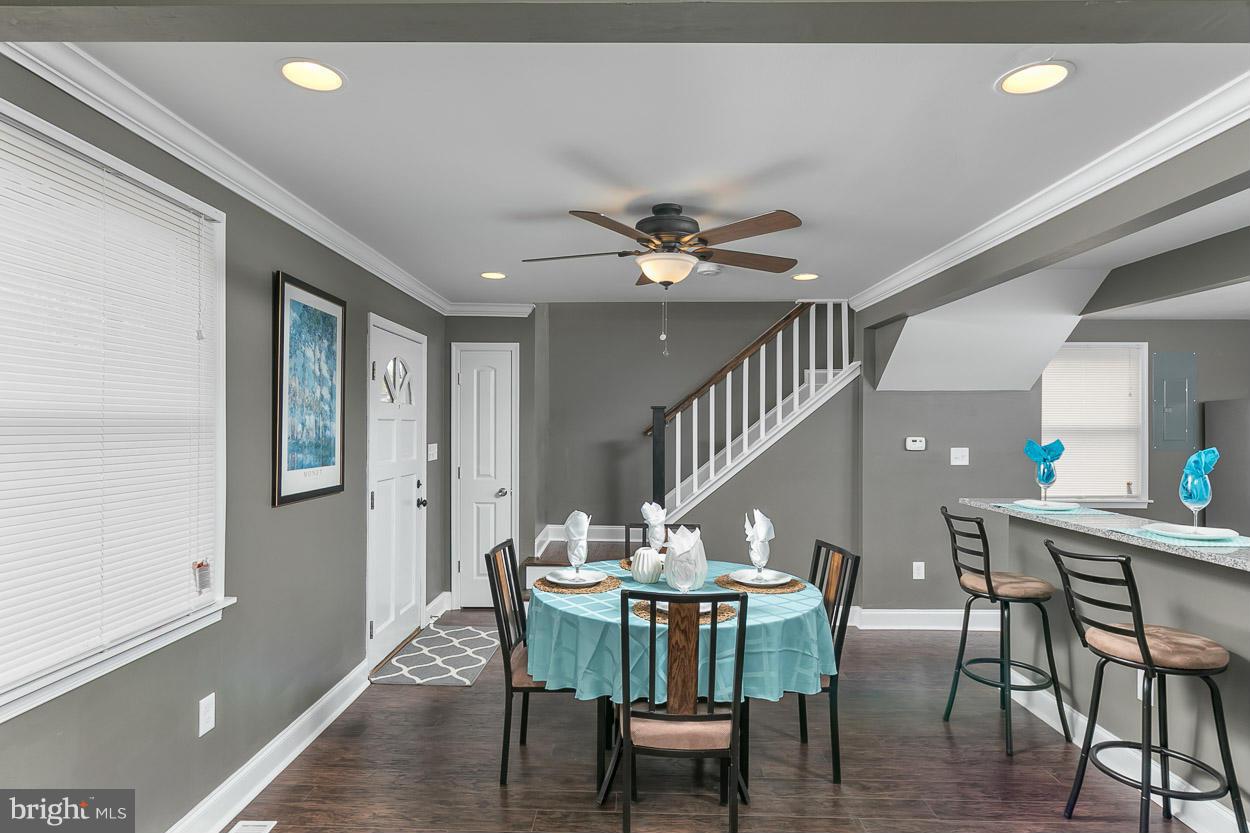 8221 Longpoint Road Baltimore, MD 21222 - Photo 9 of 24 a view of a dining room with furniture and wooden floor