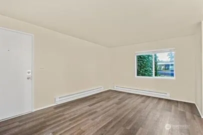 a view of a kitchen with wooden floor and a sink