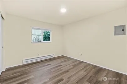 a kitchen with granite countertop white cabinets and refrigerator