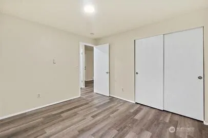 a large white kitchen with a sink and refrigerator