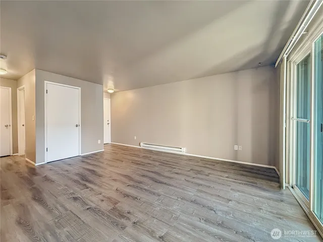 a view of a kitchen with wooden floor and electronic appliances