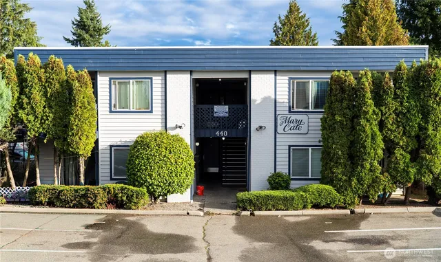 a front view of a house with a garden